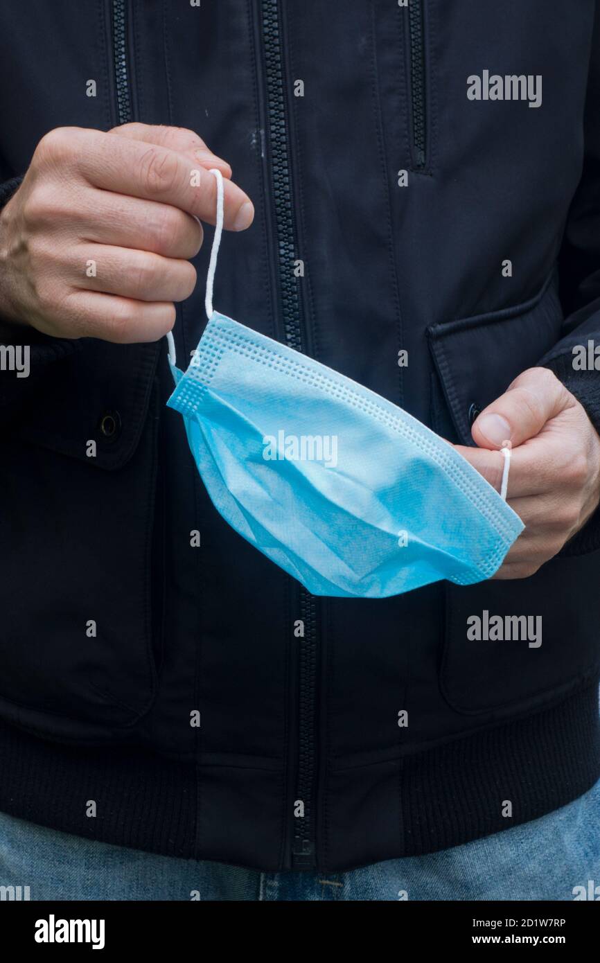 Man holding mask face hi-res stock photography and images - Alamy