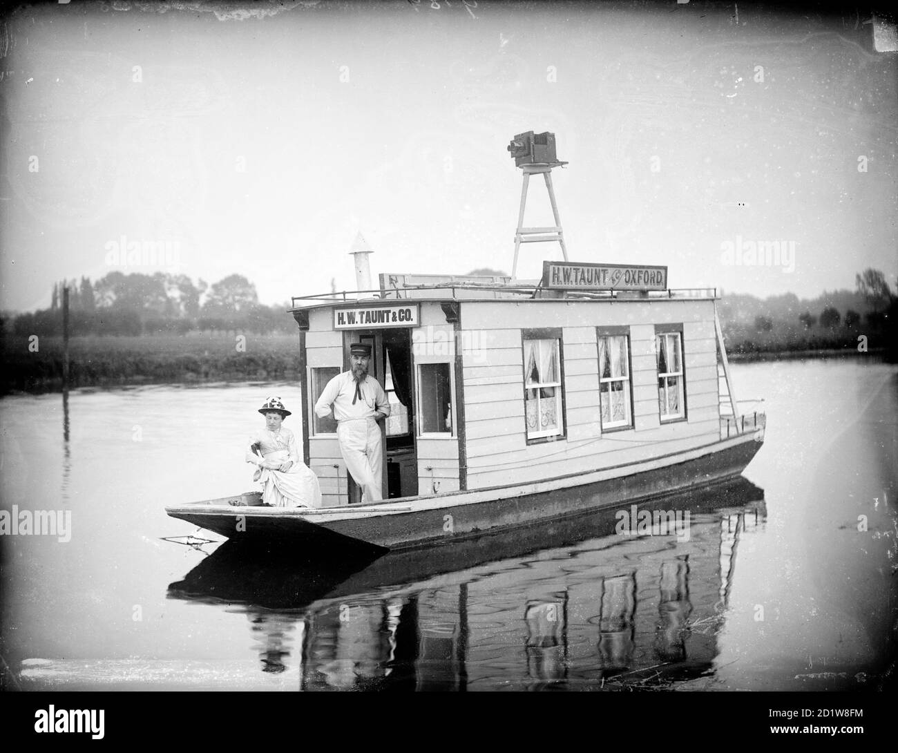 Henry Taunt on the houseboat which he used for river photography with a lady, probably his close friend Fanny Miles. Stock Photo