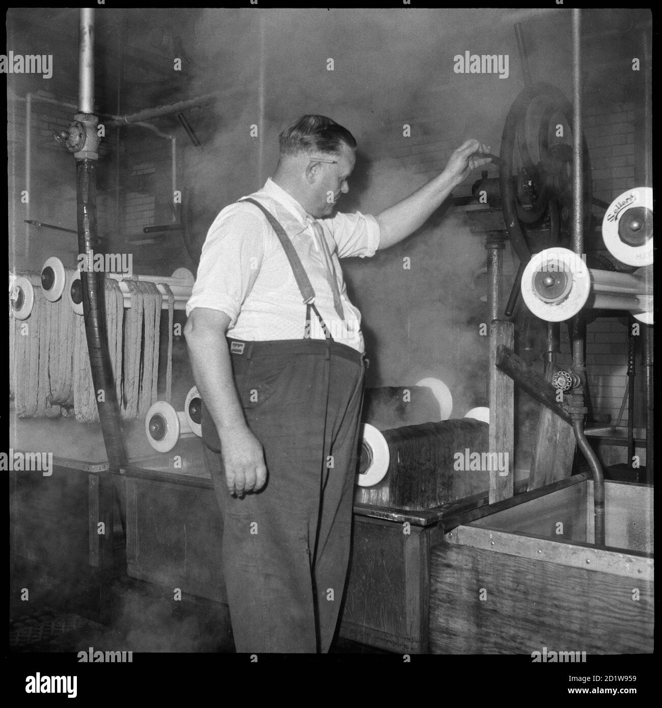 A man at work in the dyehouse of Wellington Silk Mills. Stock Photo