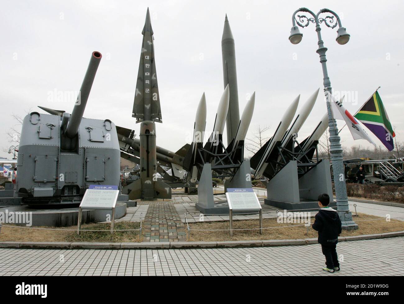 A boy looks at models of a North Korean Scud-B missile (R in the back row),  a Nike missile (L in the back row) and Hawk surface-to-air missiles (R in  the front