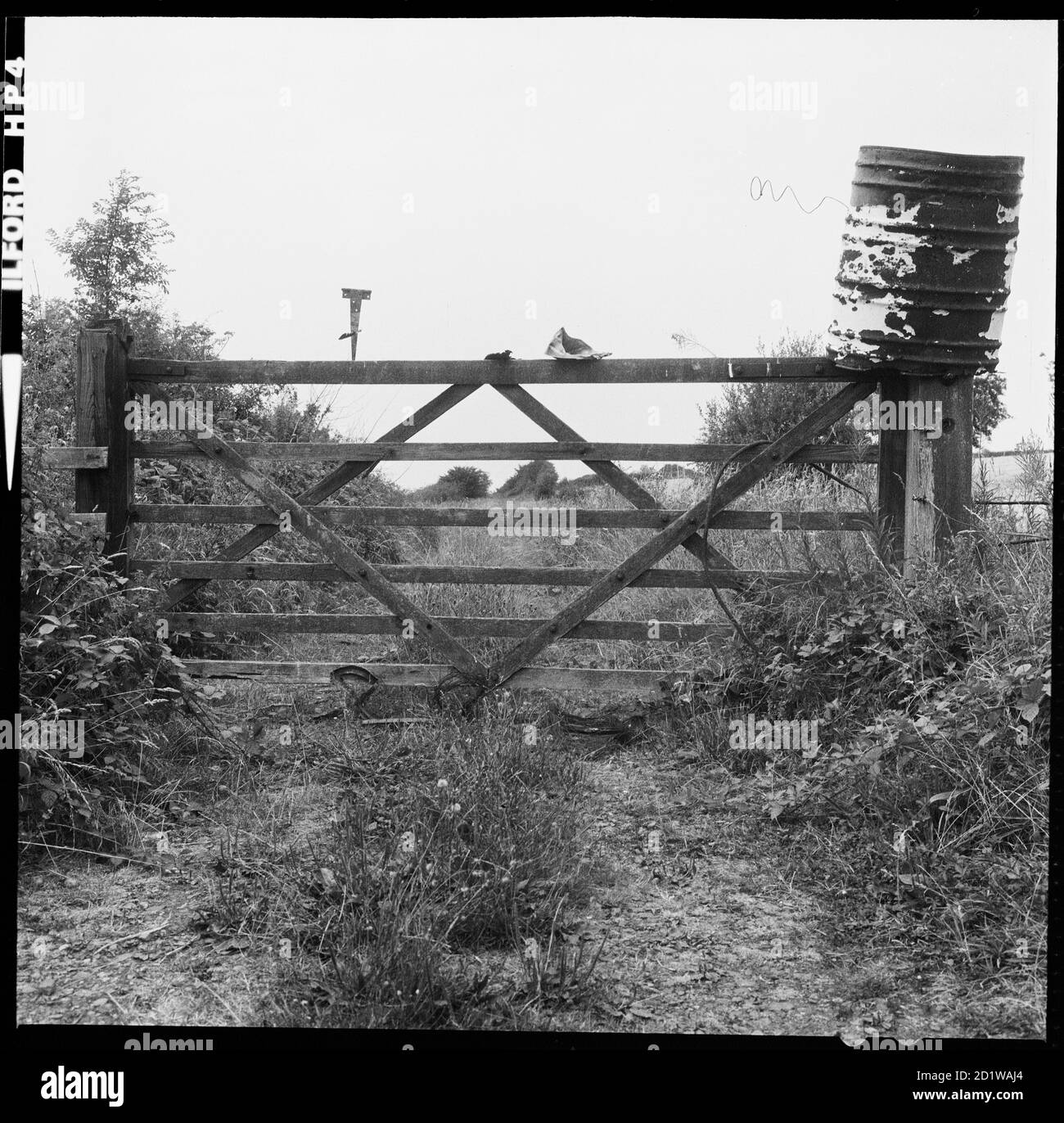Items resting on top of a wooden gate on a trackway, possibly around Herefordshire / the West Midlands. Stock Photo
