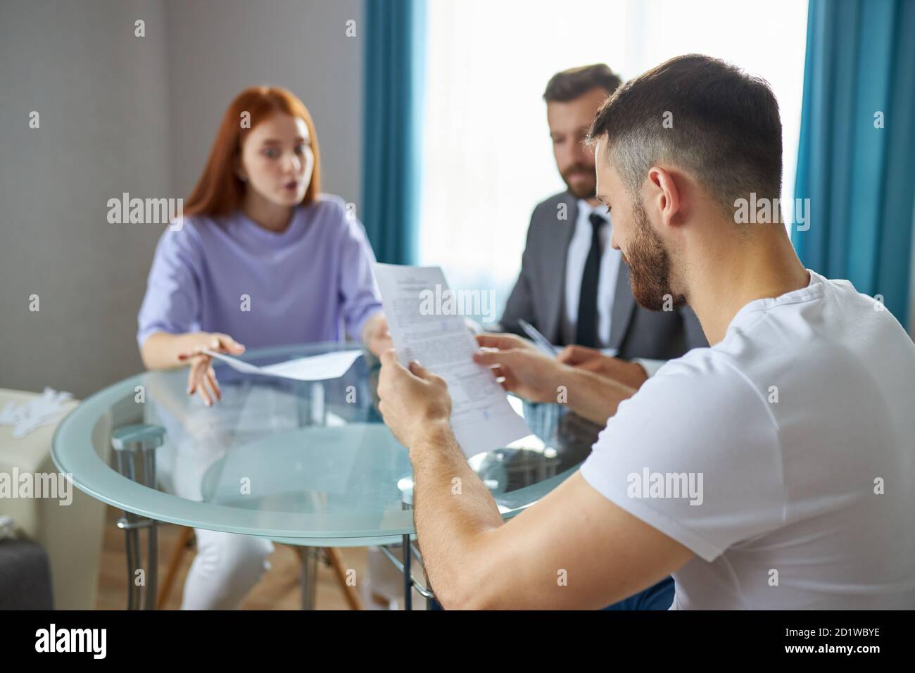 young caucasian couple visiting professional lawyer, refuse sign decree paper and finalize divorce. at marriage consultant or agent office. family separation, divorce concept Stock Photo