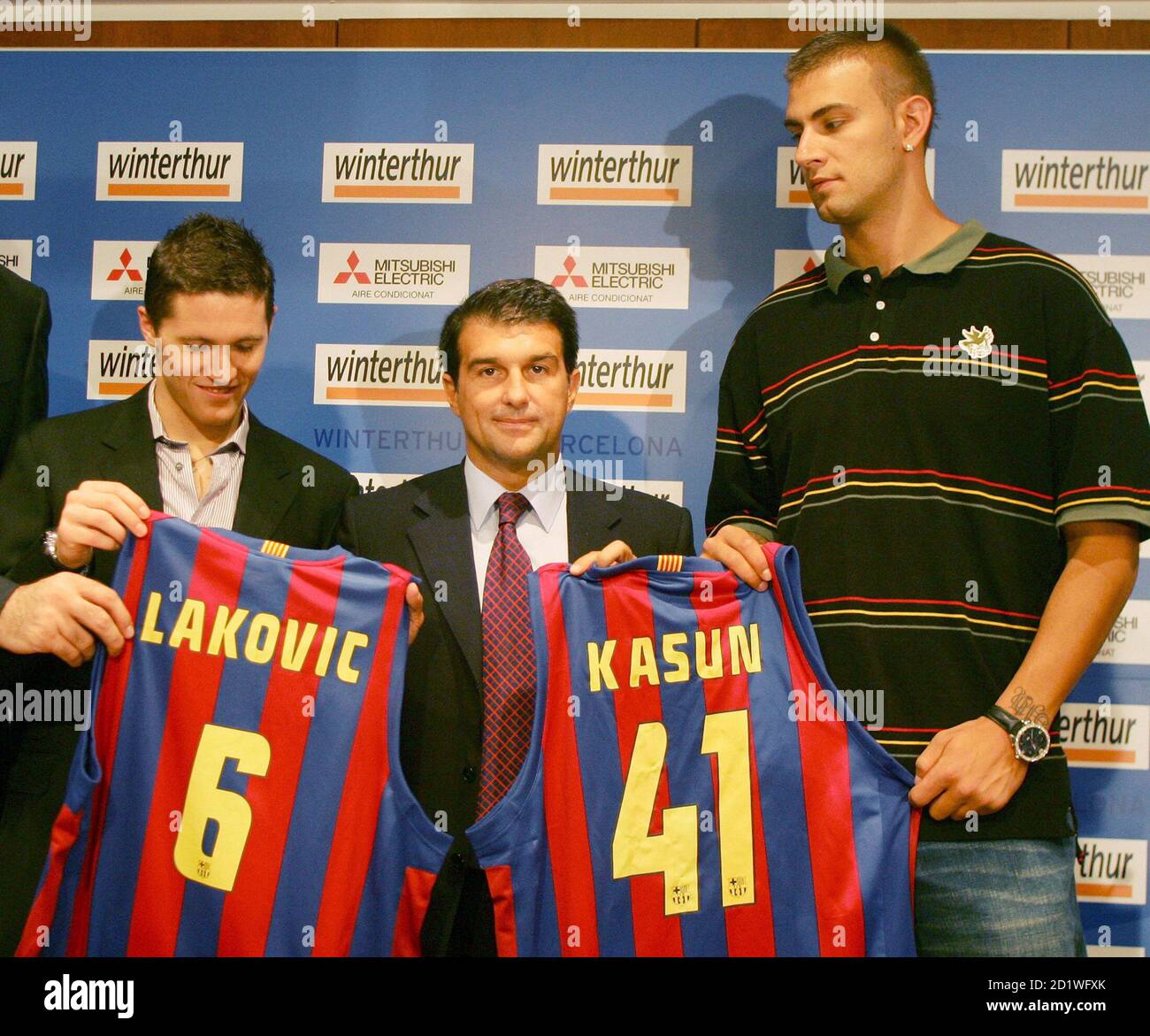 Barcelona's President Joan Laporta (C), Slovenian base Jaka Lakovic (L)  from Greek outfit Panathinaikos, and Croatian center Mario Kasun from the  NBA Orlando Magic, hold up Barcelona jerseys as they pose for