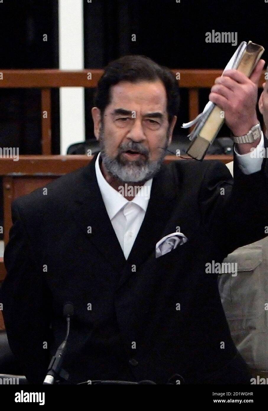 Former Iraqi President Saddam Hussein Holds A Holy Koran In His Hand As He Reacts To The Verdict During His Trial Held Under Tight Security In Baghdad S Heavily Fortified Green Zone November