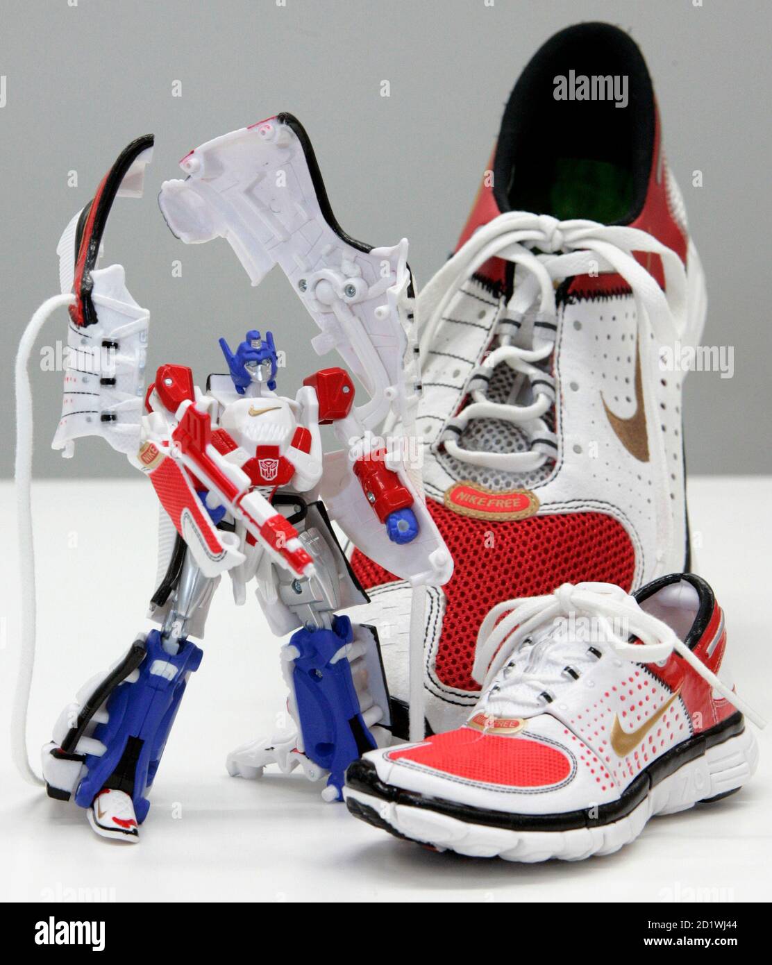 The Japanese toymaker Tomy Company's 'Transformers Sports Label Convoy  feat. Nike Free 7.0', which transforms from a pair of plastic half-scale  Nike shoes (bottom) into a robot named 'Convoy' (L), is displayed
