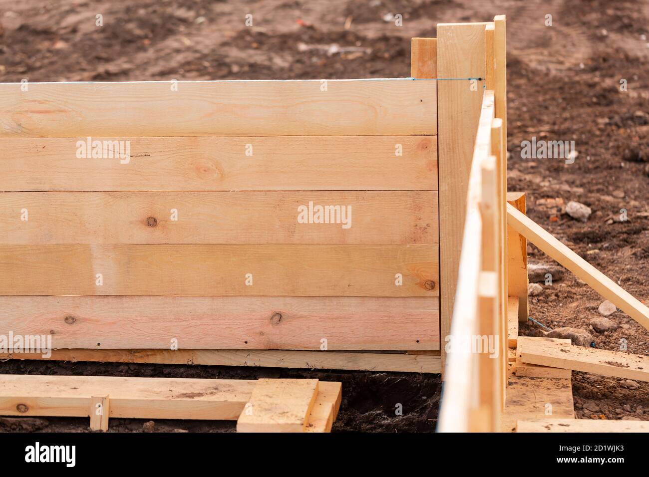 Wooden formwork for creating strip foundation for new house basis. Constructing house from the beginning concept Stock Photo