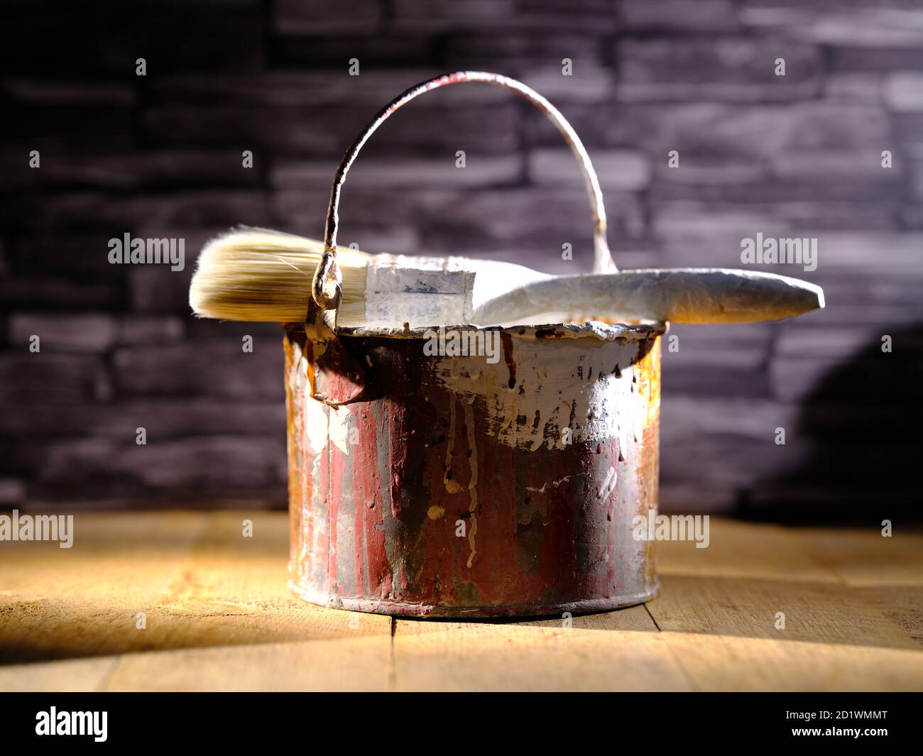 Paint tin bucket splattered with red and white paint with old paint