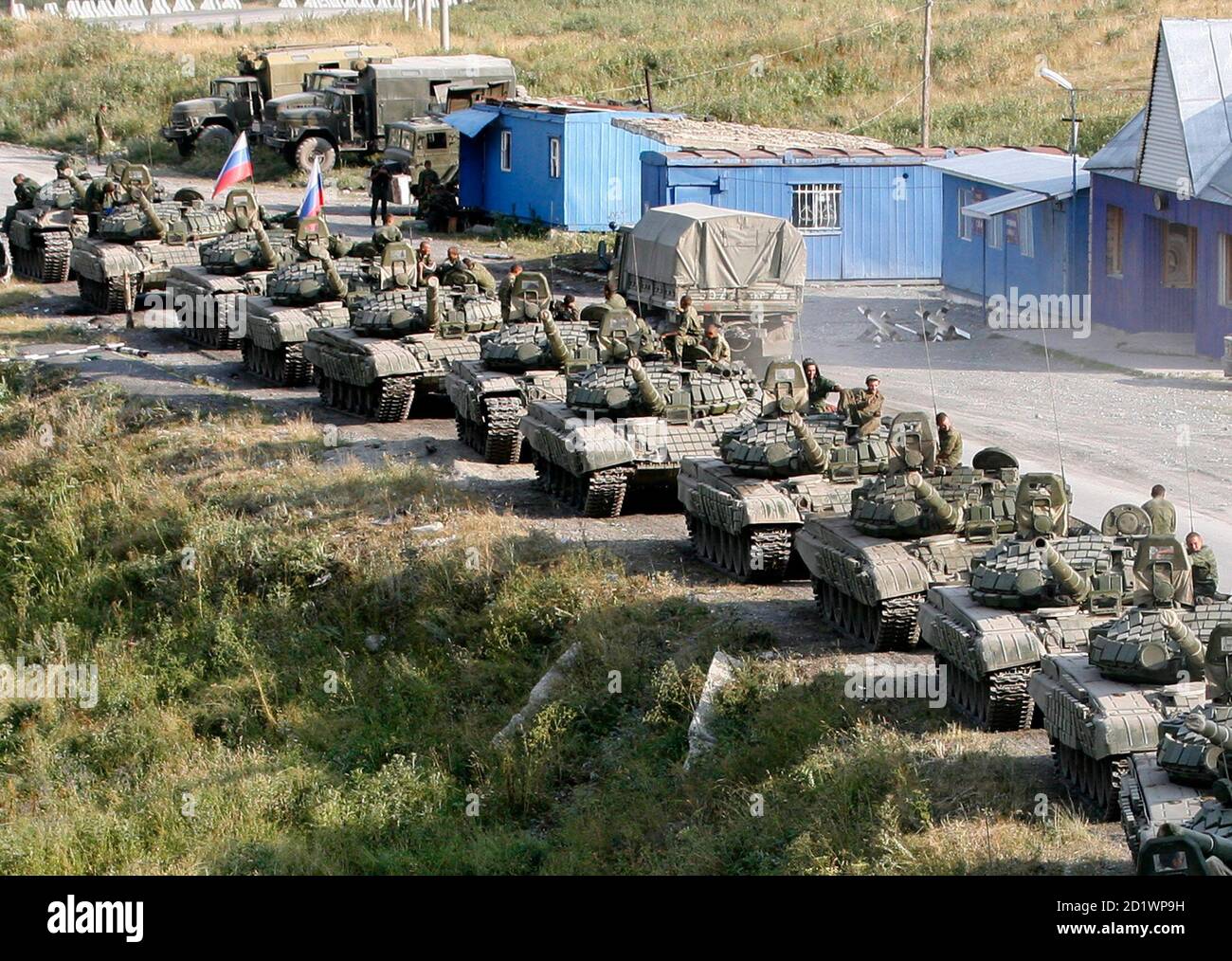 A column of Russian armoured vehicles moves along a road in South Ossetia, near the border with North Ossetia August 23, 2008. Russia must immediately withdraw from Georgia and pull its troops back to positions held before the outbreak of hostilities in the country, a German government spokesman said on Saturday. REUTERS/Sergei Karpukhin (GEORGIA) Stock Photo