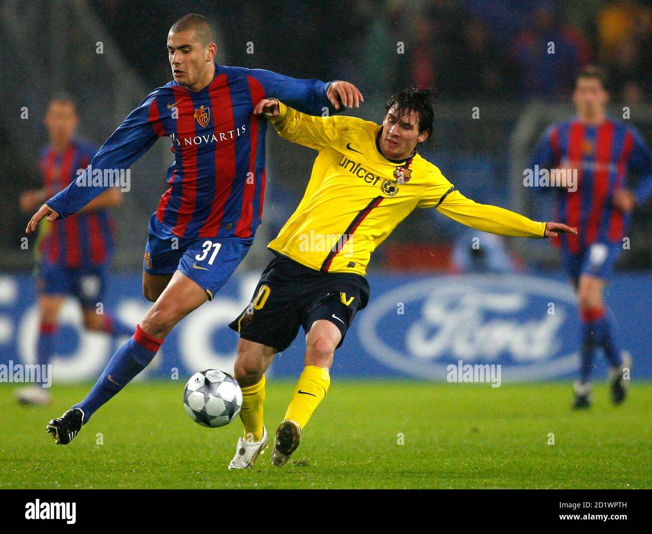 FC Basel's Eren Derdiyok (L) challenges Lionel Messi of Barcelona during  their Champions League soccer match in Basel October 22, 2008.  REUTERS/Christian Hartmann (SWITZERLAND Stock Photo - Alamy