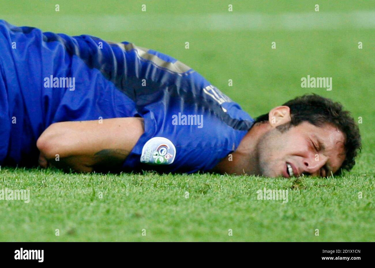 Italy's Marco Materazzi lies on the pitch after being head-butted by France's Zinedine Zidane during their World Cup 2006 final soccer match in Berlin July 9, 2006. FIFA RESTRICTION - NO MOBILE USE REUTERS/Jerry Lampen (GERMANY) Stock Photo