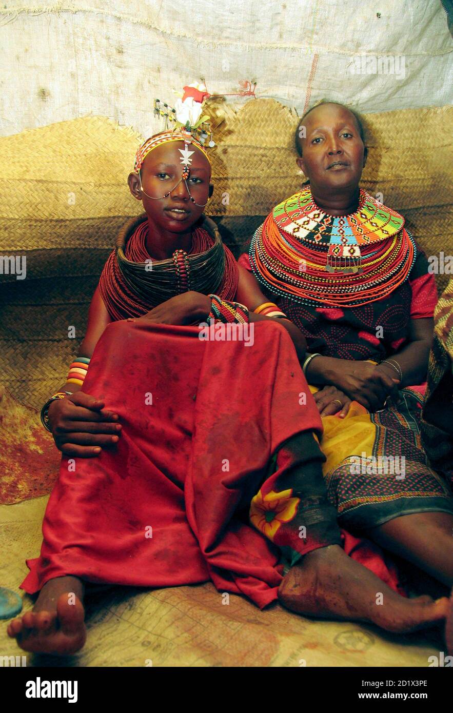 A Bride L From Kenya S Smallest Ethnic Group El Molo With Her Dress And Feet Stained Of Blood Sits Next To Her Mother After Been Circumcised Before Her Wedding Ceremony In El Molo Bay A Bride L From Kenya S Smallest Ethnic Group El Molo With Her Dress And Feet Stained Of Blood Sits Next To Her Mother After Been Circumcised Before Her Wedding Ceremony In El Molo Bay