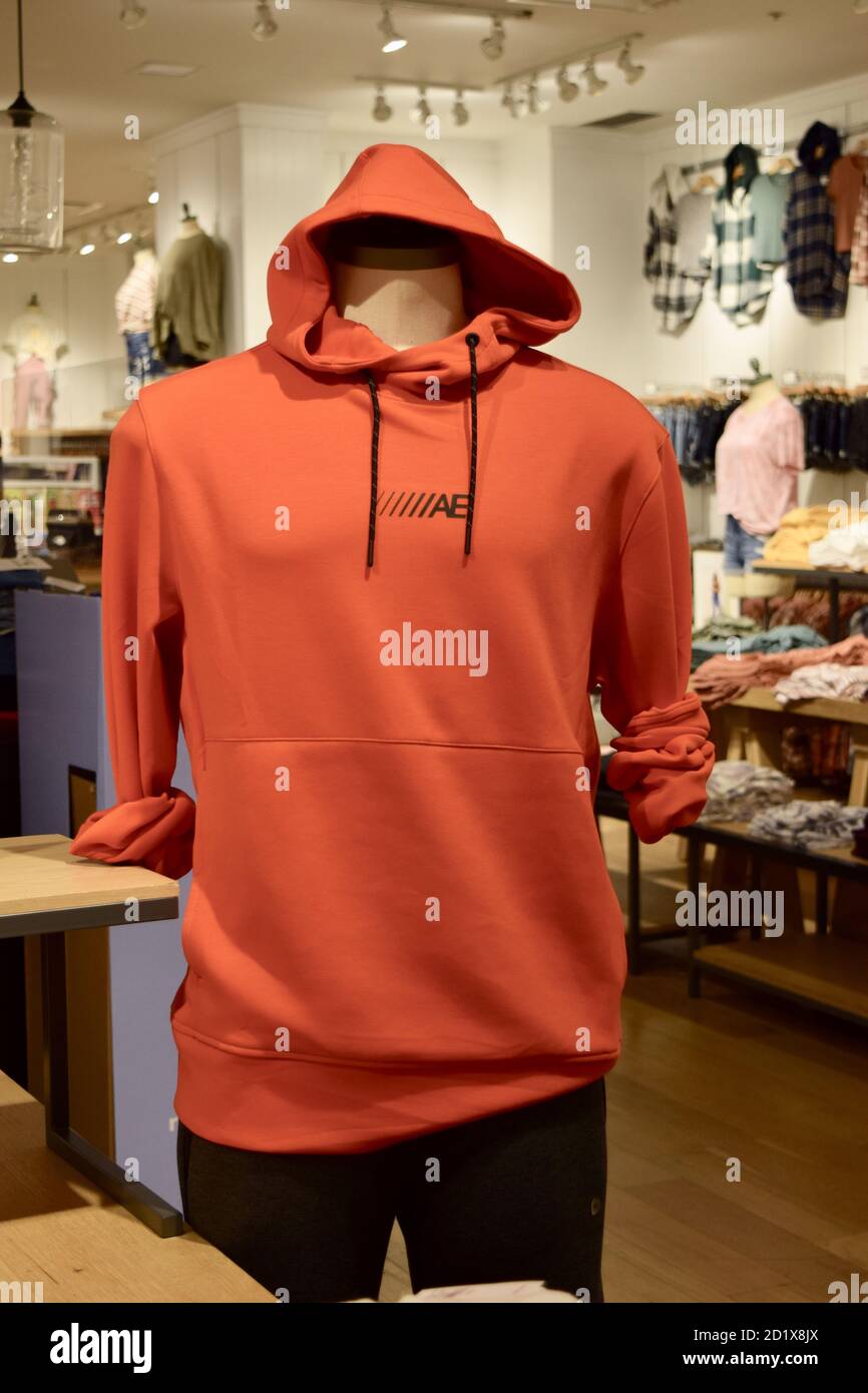 FRESNO, UNITED STATES - Sep 01, 2020: A mannequin wearing Mens AE brand name bright orange hood with strings pullover Stock Photo