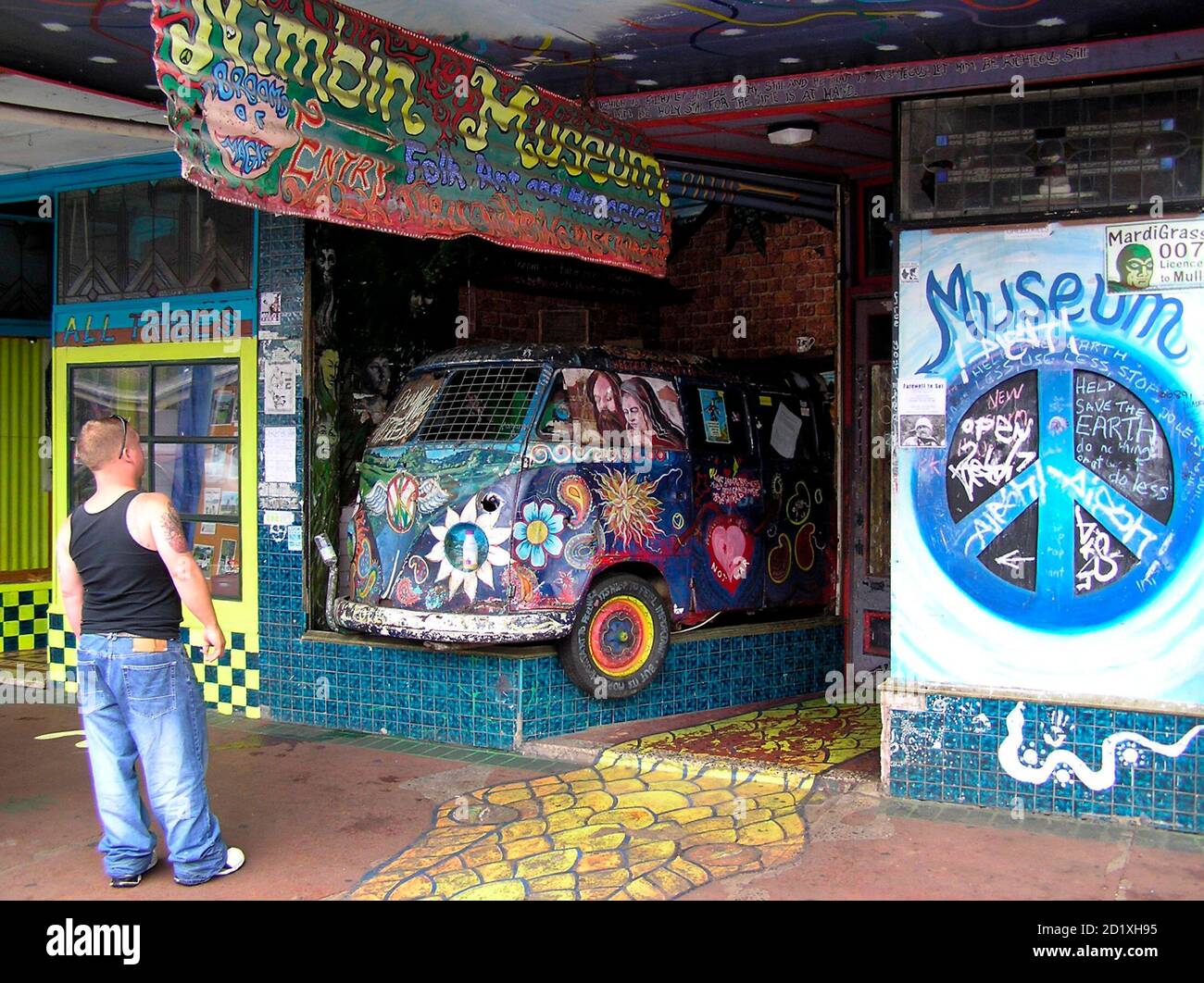 A tourist inspects the Nimbin Museum on the main street of Australia's hippy capital Nimbin on April 12, 2007. The museum promotes the hippy way of life which involves the freedom to smoke marijuana. The village of Nimbin on Australia's fertile northeast coast was born at the 1973 Aquarius hippy festival and has battled authorities for 34 years to survive. But now hippies fear rampant coastal development will destroy their laid-back way of life. Picture taken April 12, 2007.  To match feature AUSTRALIA-HIPPIES  REUTERS/Michael Perry   (AUSTRALIA) Stock Photo