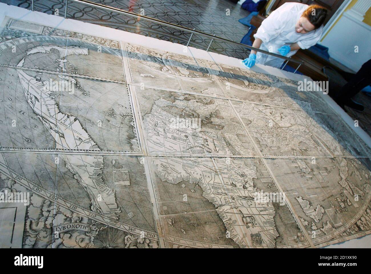 A conservator at the Library of Congress touches up the map that first used the name America as it is prepared for its encasement in Washington December 3, 2007. The 500-year-old map, created by German monk Martin Waldseemuller, is the only known surviving copy and was purchased for $10 million in 2003.    REUTERS/Jim Young   (UNITED STATES) Stock Photo