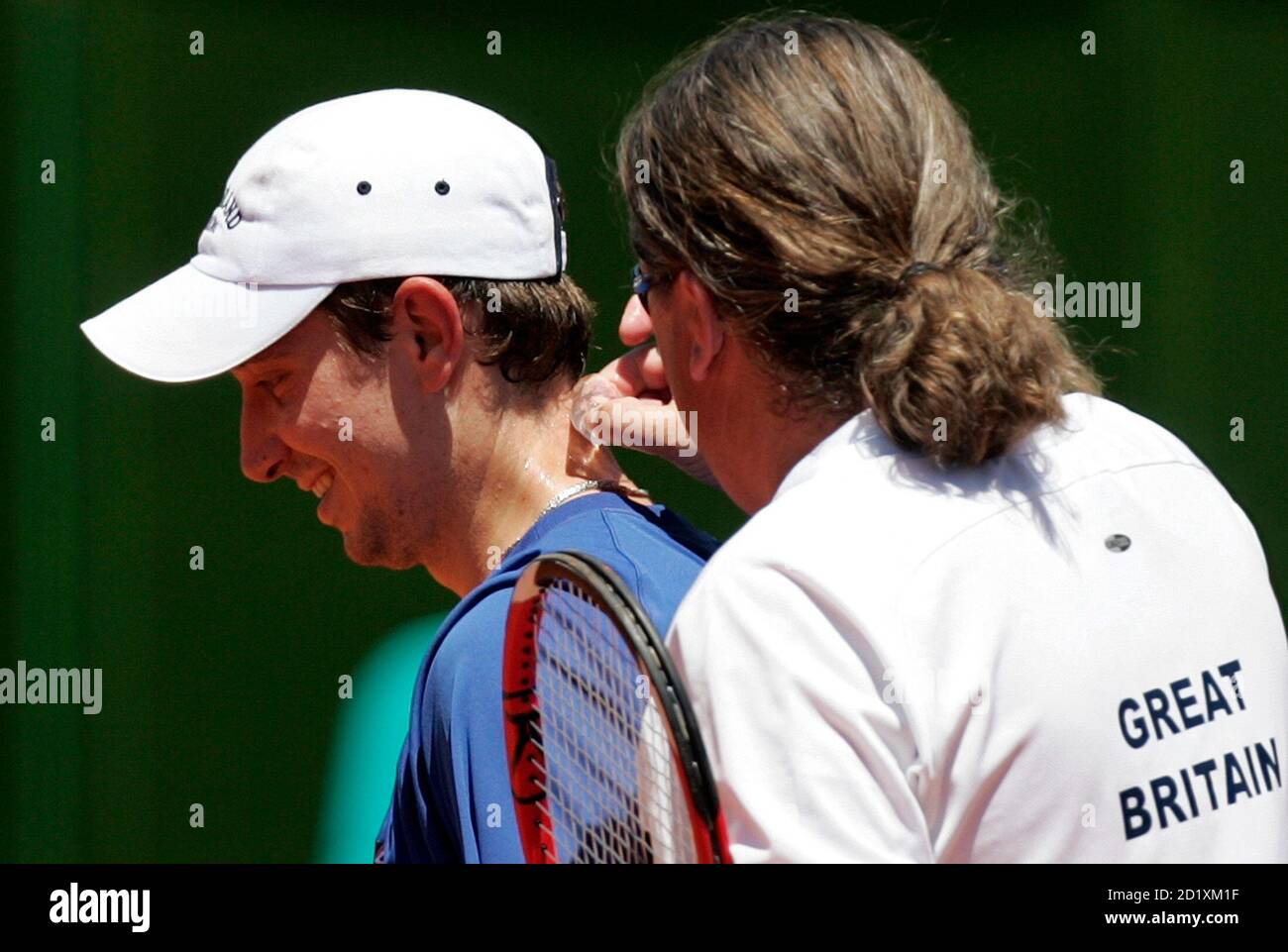 Britain's coach Peter Lundgren (R) places an ice cube on tennis player Alex  Bogdanovic's neck during a training session ahead of their first round  Davis Cup match against Argentina in Buenos Aires
