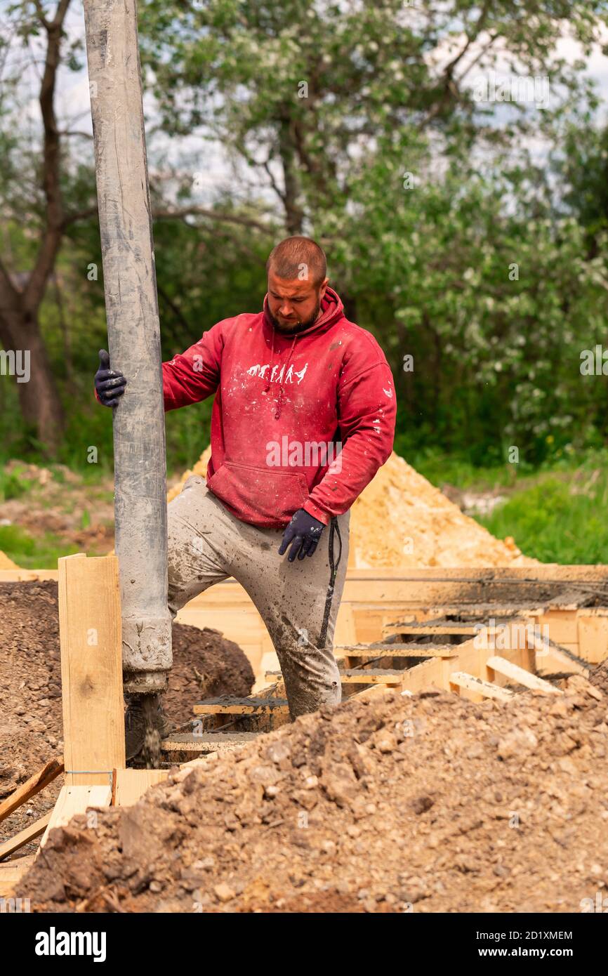 Construction Worker Laying Cement Or Concrete Into The Foundation ...