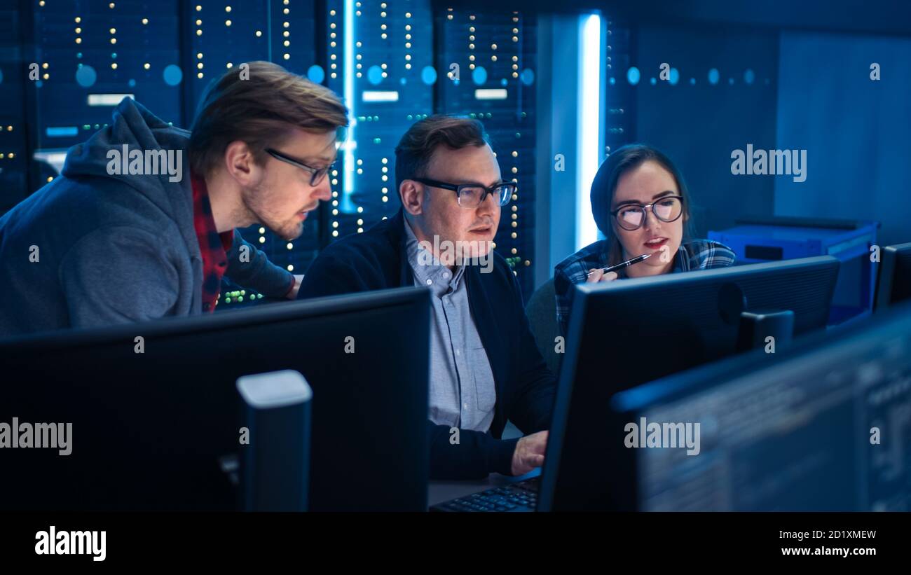 Three IT Engineers Programmers Talking about Work, Using Computers ...