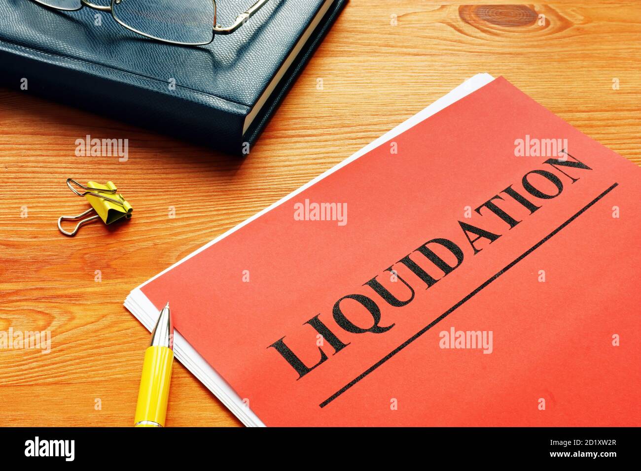 The word liquidation is printed on the red page. Stock Photo