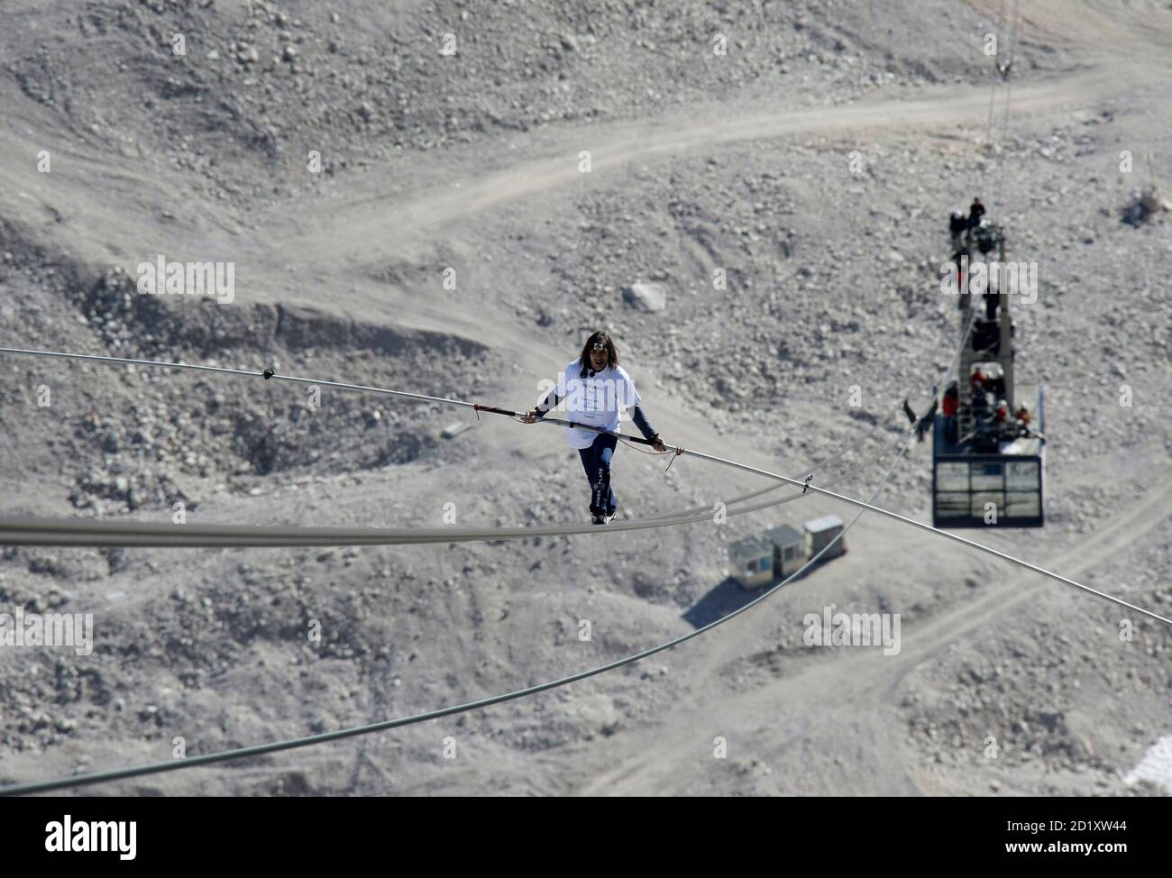 Freddy Nock from Switzerland balances on the ropeway of a cable car leading  on Germany's highest