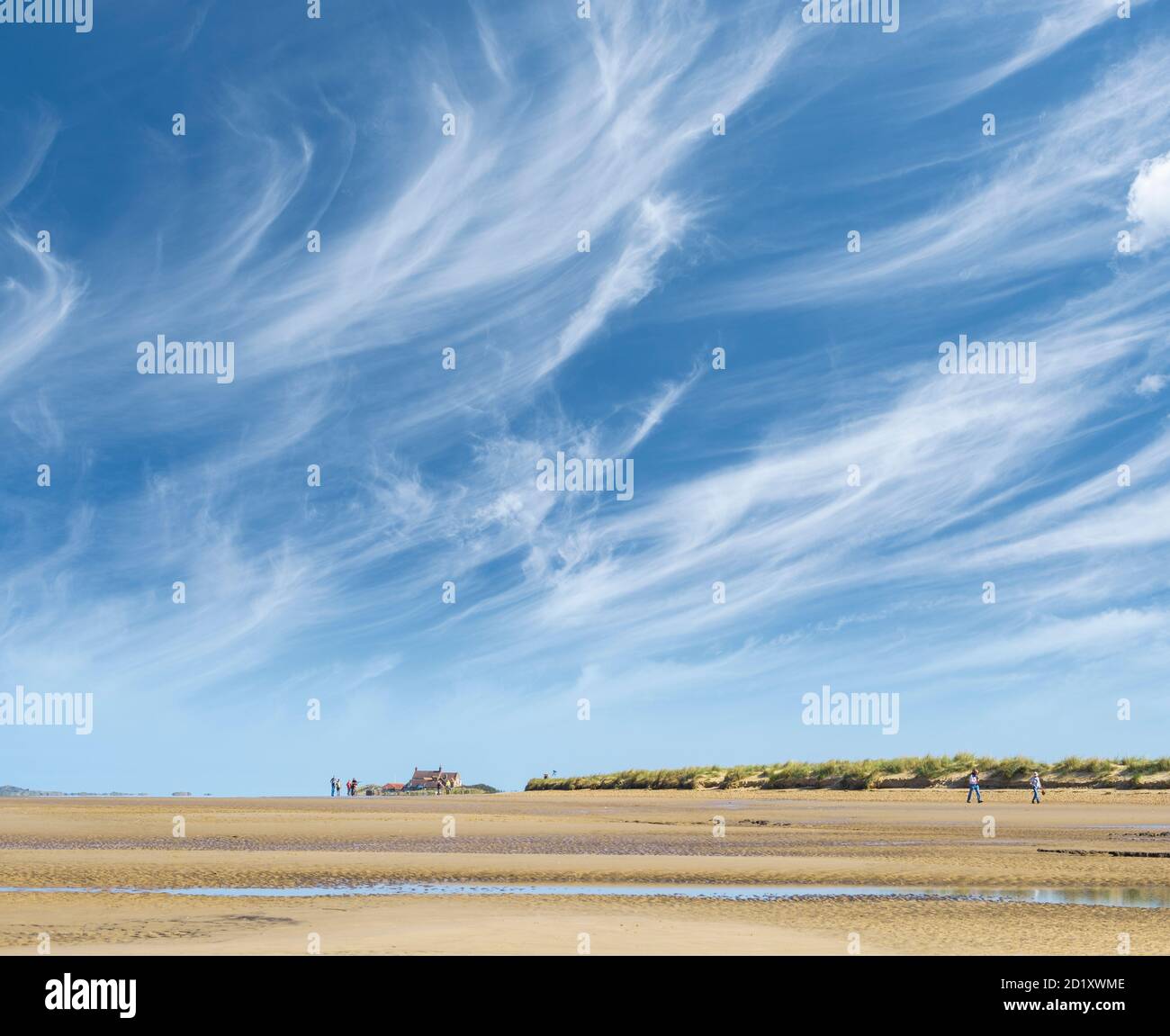 Cirrus clouds above a quiet Norfolk beach. Stock Photo