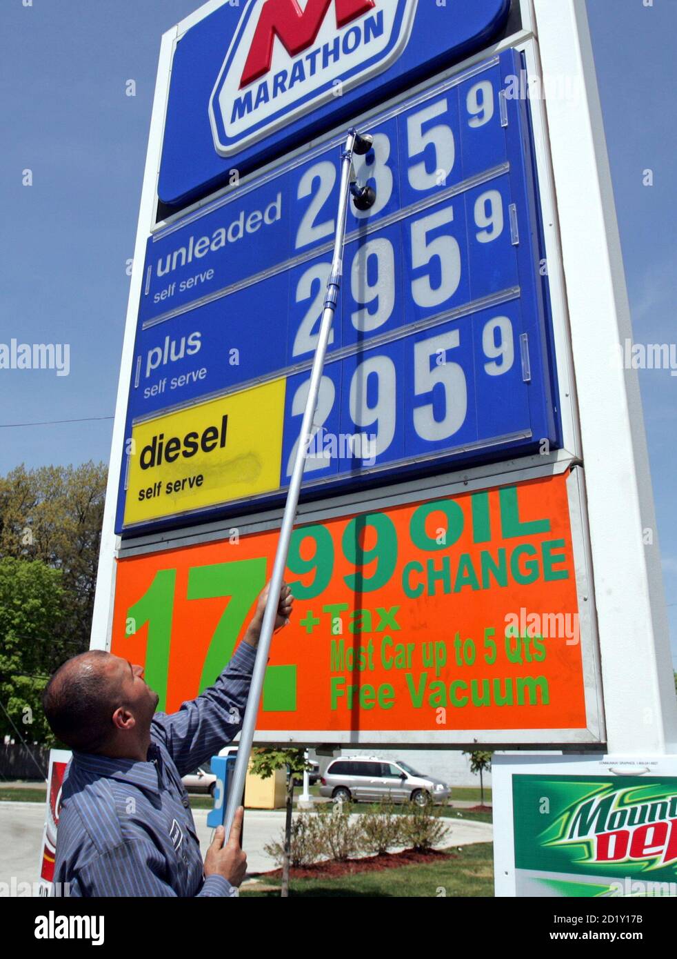 Gas station attendant Ahmad Mallah raises the price of regular gasoline