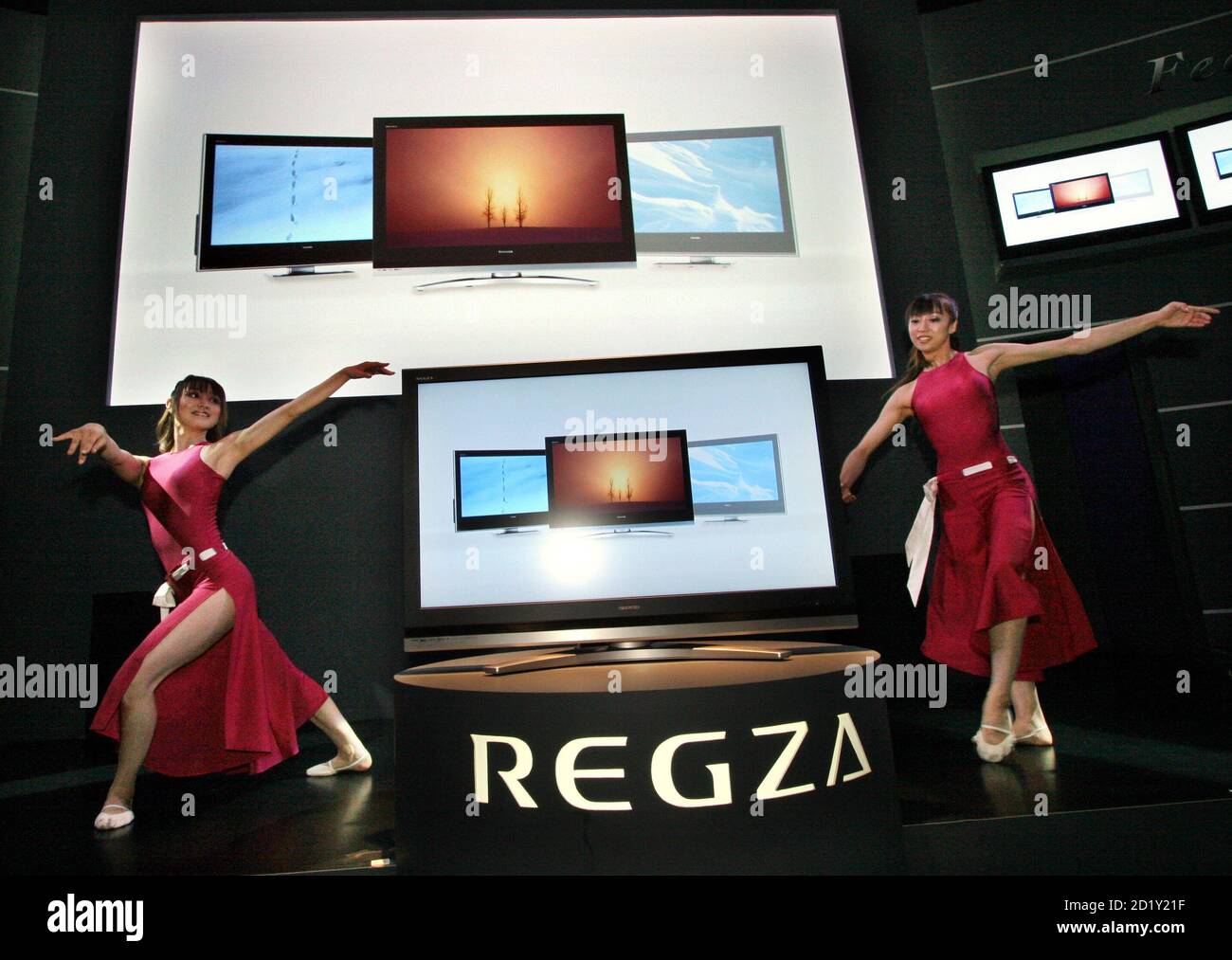 Models perform next to a flat-panel TV Regza at Japan's biggest technology trade show (CEATEC) in Makuhari, northeast of Tokyo in this October 3, 2006 file photo. Forget the giant flat-screen TVs and snazzy mobile phones. At Japan's biggest technology trade show on Friday, visitors aimed their cameras at the women in miniskirts lining up in front of the gadgets to wave visitors goodbye. For the women, too, these events are often more than just a decent paying part-time job.  REUTERS/Toshiyuki Aizawa/Files (JAPAN) Stock Photo