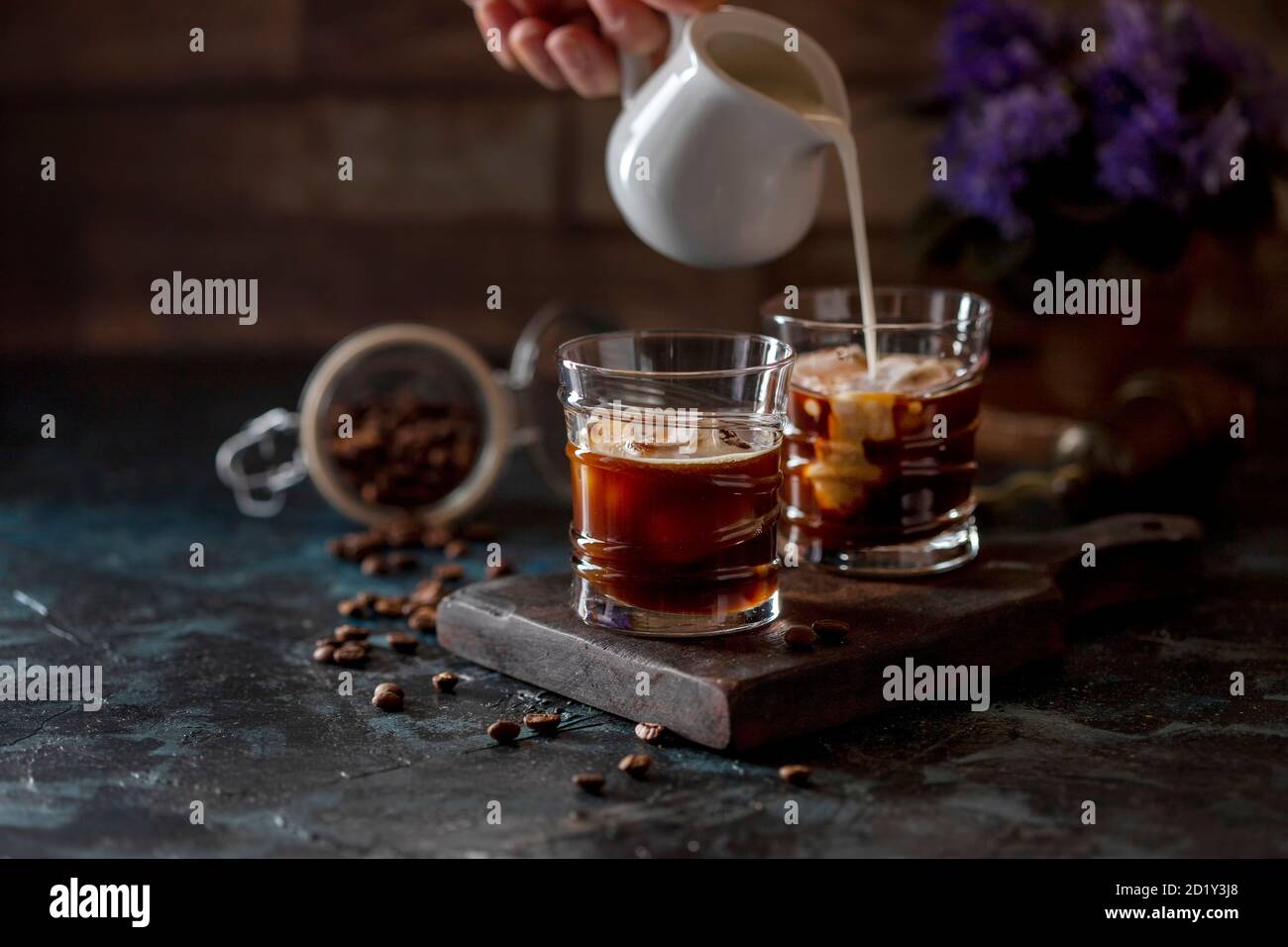 https://c8.alamy.com/comp/2D1Y3J8/ice-coffee-espresso-a-glasses-with-milk-being-poured-over-from-pitcher-by-hand-summer-refreshing-beverage-2D1Y3J8.jpg