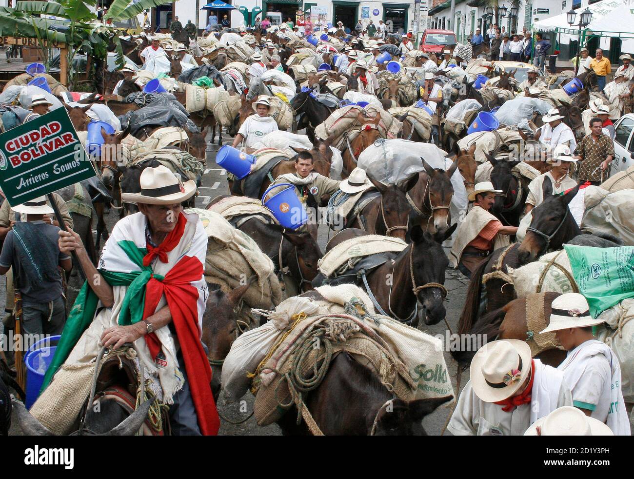 Colombian farmers called "Arrieros" walk with their mules along a street in  El Retiro May 18, 2007. Arrieros from all over the country travel to  Medellin each year, where they put on