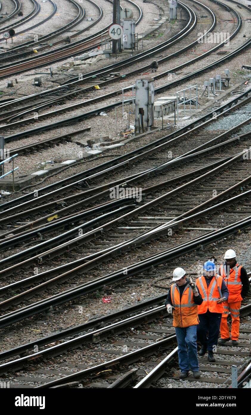Network Rail workers walk along railway tracks in London February 28, 2008.  Britain's rail infrastructure firm Network Rail was fined 14 million pounds ($28 million) on Thursday over delays in track projects which disrupted New Year services.  REUTERS/Luke MacGregor   (BRITAIN) Stock Photo