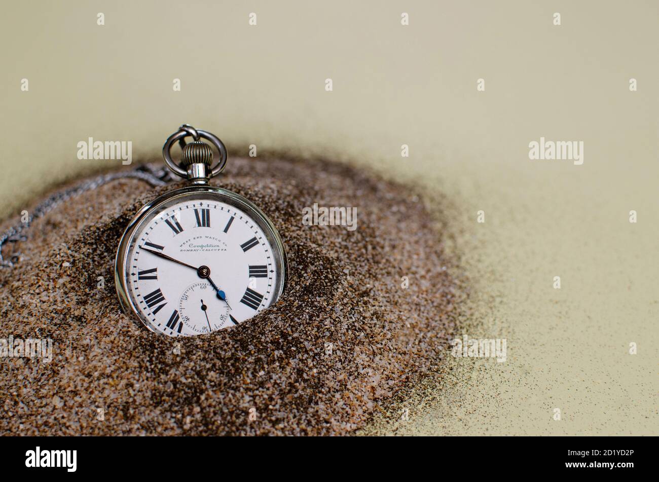 Old pocket watch against black cushion and grey textured background.  Roman nos indicating time Stock Photo