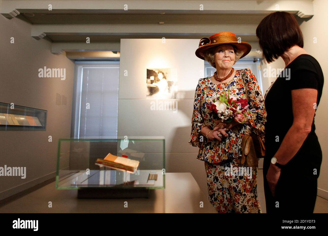 Dutch Queen Beatrix (L) stands next to the well-known first diary of Anne Frank, on display in the Anne Frank House in Amsterdam April 28, 2010. Fifty years after the opening of the Anne Frank House museum, which has more than 1 million visitors every year, the museum is launching an online virtual tour of what life was like at the back of 263 Prinsengracht in Amsterdam. To match Reuters Life! ANNEFRANK-TOUR/   REUTERS/Cris Toala Olivares (NETHERLANDS - Tags: SOCIETY ROYALS TRAVEL) Stock Photo