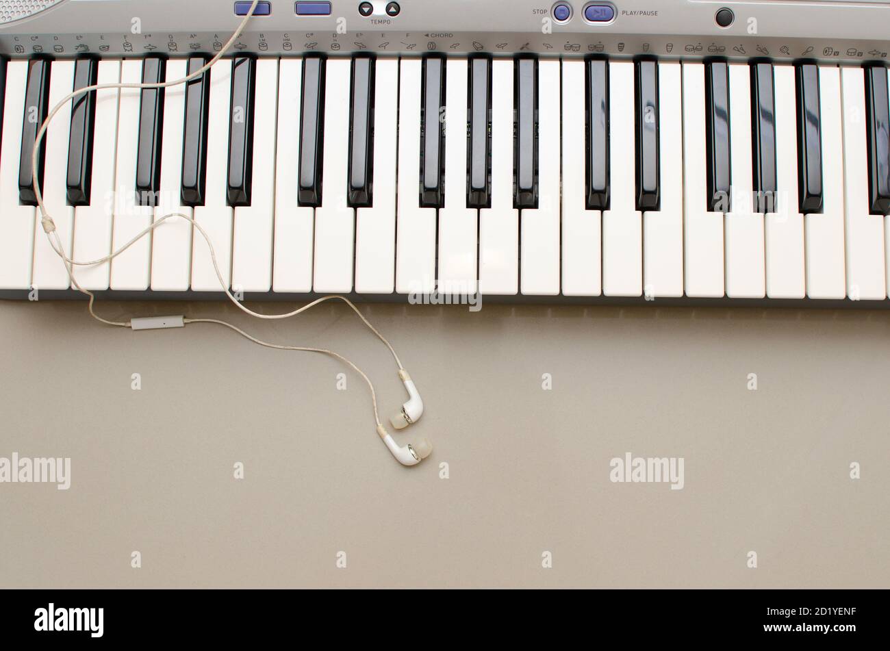 Keyboard  of Synthesiser or Electronic musical instrument with ear buds or ear phones Stock Photo