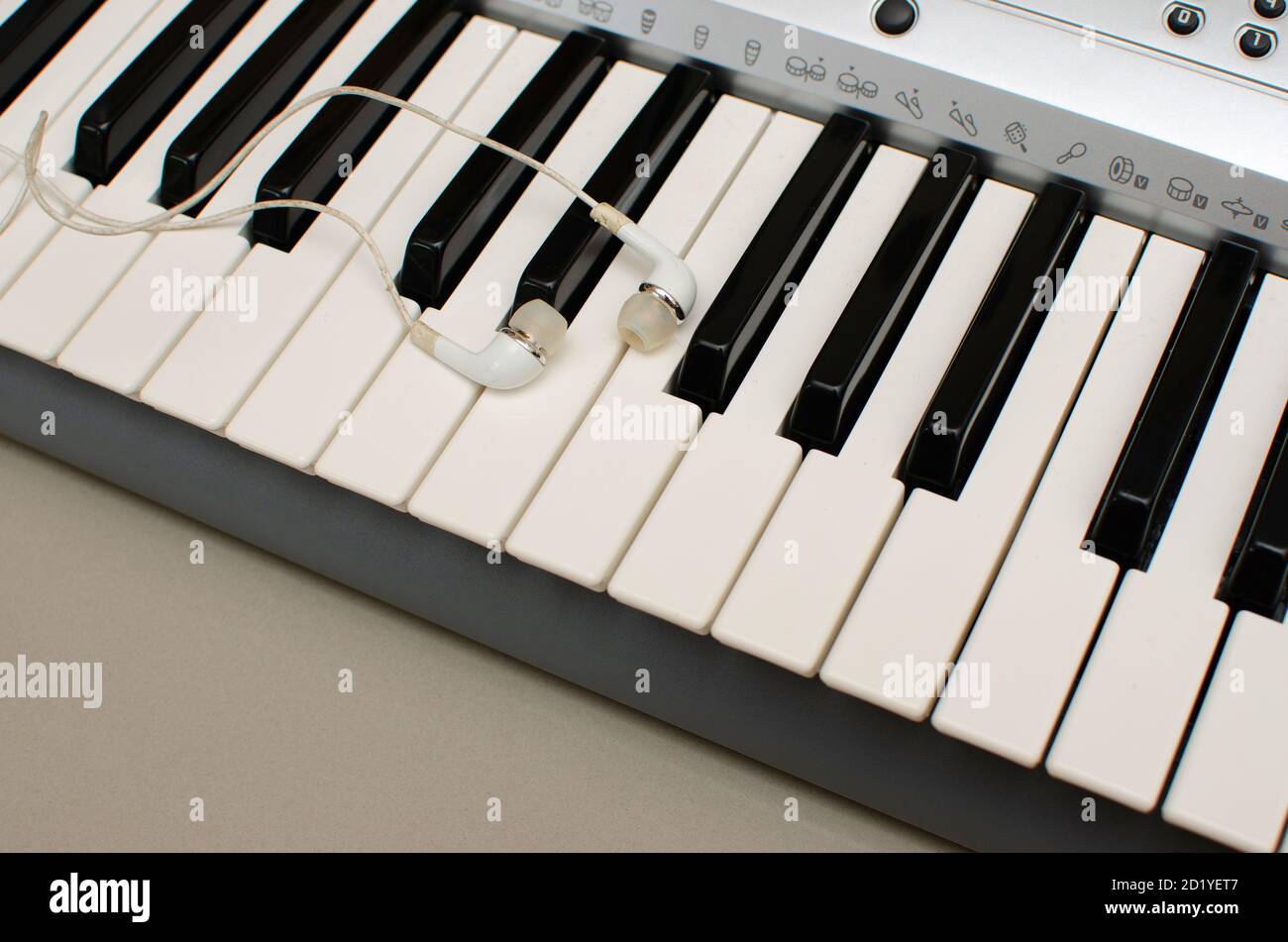 Keyboard  of Synthesiser or Electronic musical instrument with ear buds or ear phones Stock Photo