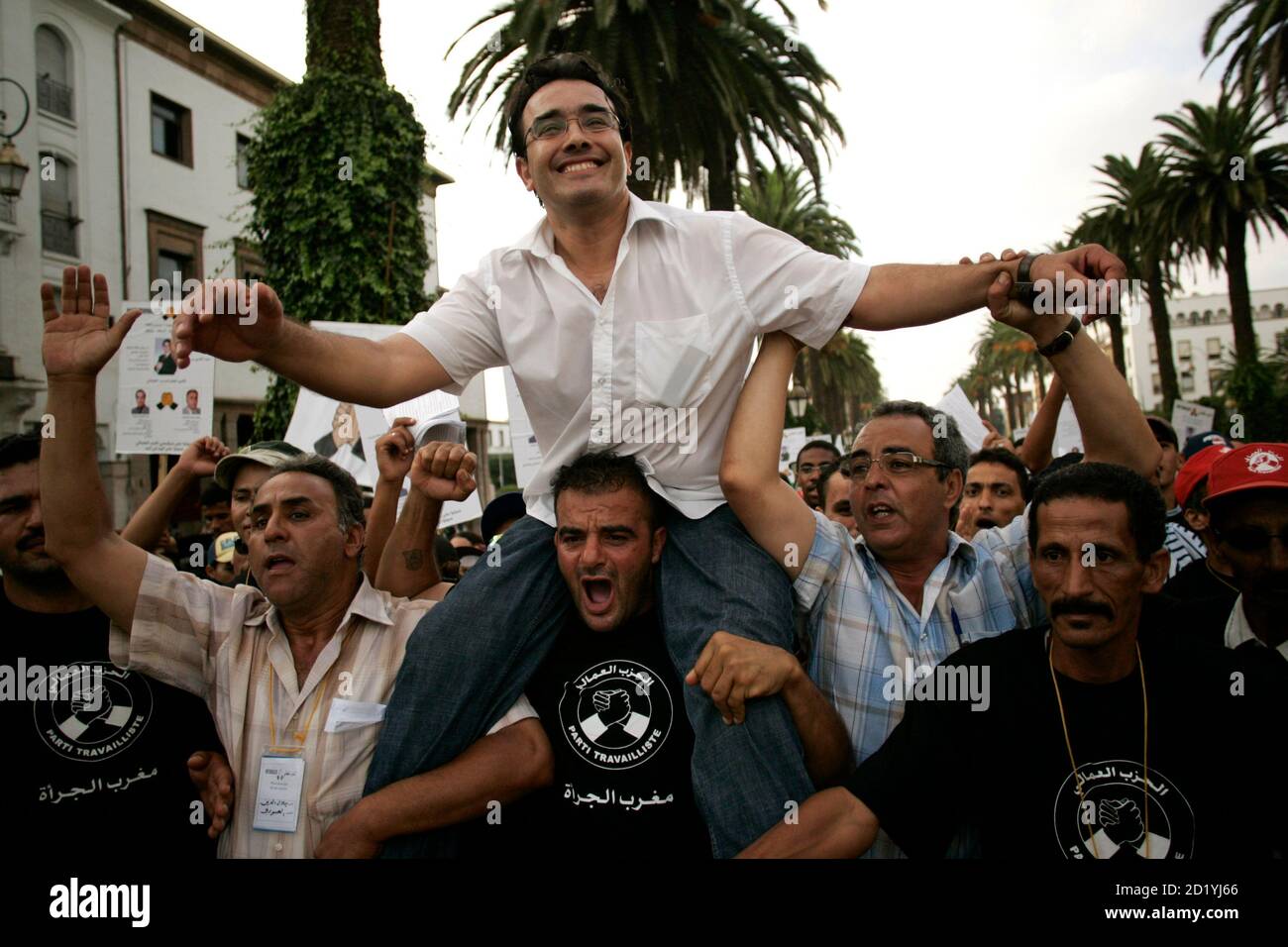Supporters of the Labour Party carry their leader, Abdelkrim Ben Atique, during a march in Rabat September 1, 2007.  Parliamentary elections in Morocco will be held on September 7. REUTERS/Rafael Marchante (MOROCCO) Stock Photo