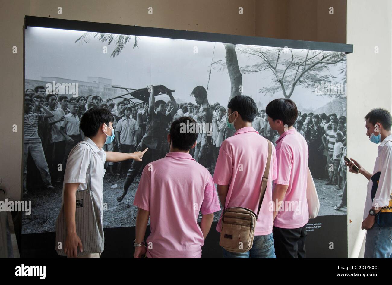 A group of students attend an exhibition during the 44th anniversary of the Thammasat massacre.The 6 October 1976 Thammasat University massacre was a violent crackdown by Thai police joined with right-wing paramilitaries against leftist protesters and students who had occupied Bangkok's Thammasat University. Stock Photo