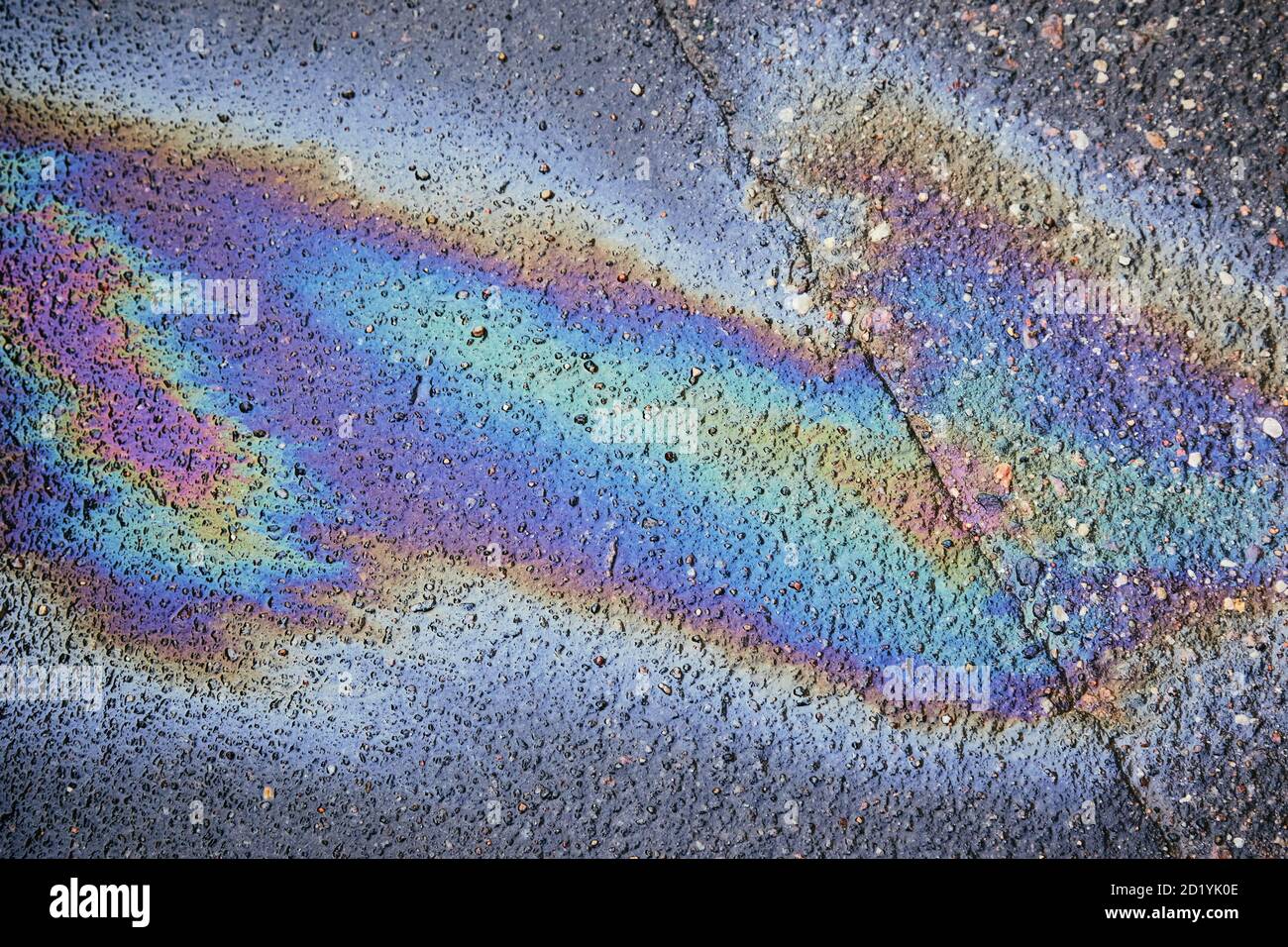 Gas stain on wet asphalt caused by a leak under a car or truck Stock Photo Alamy