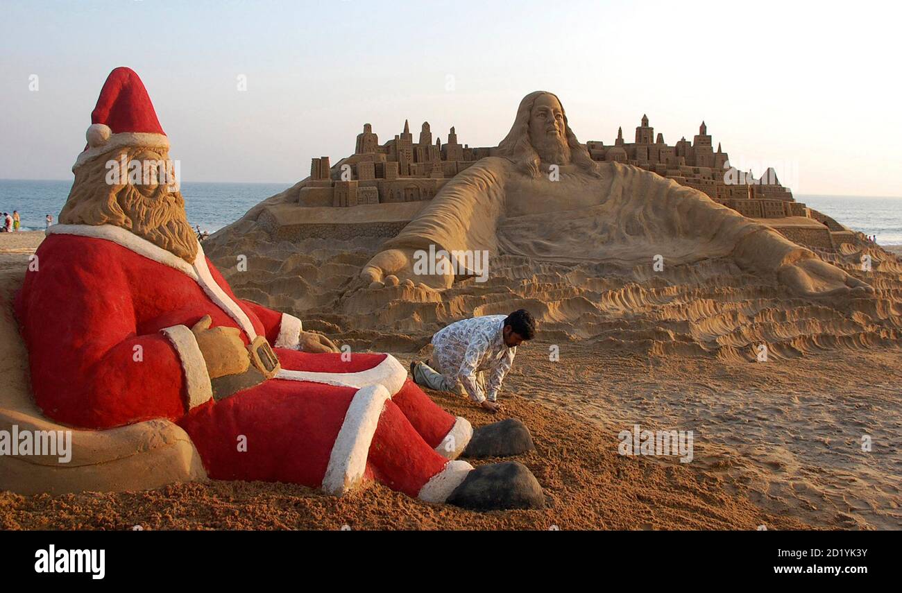 Sand artist Sudarsan Patnaik creates sand sculptures of Santa Claus and  Jesus Christ on Christmas eve at a beach in Puri, close to the eastern  Indian city of Bhubaneshwar, December 24, 2007.