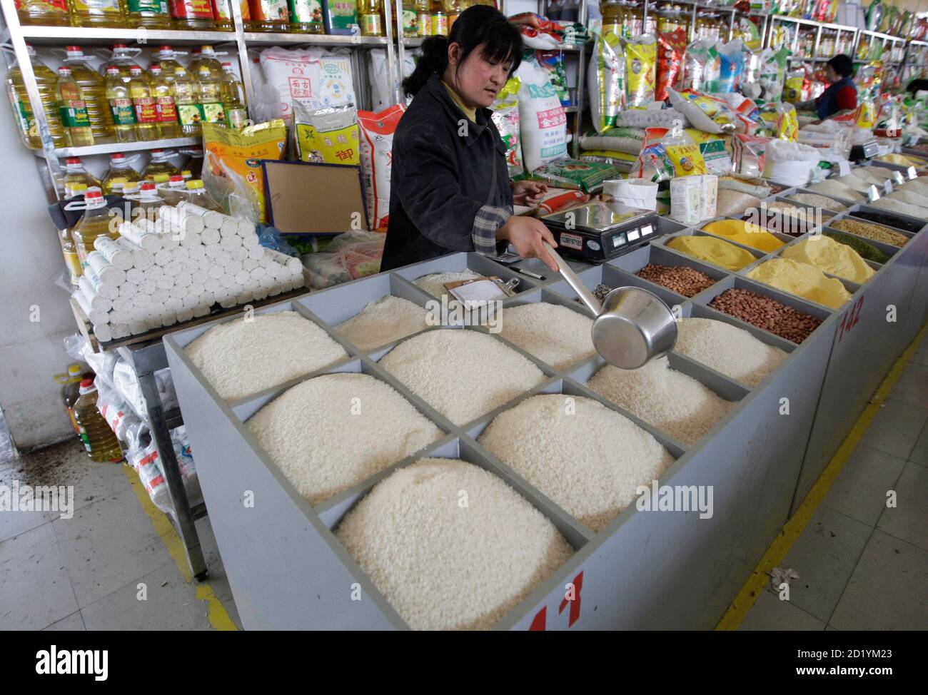 A vendor sells rice at a market in Beijing April 3, 2008. World rice production is set to increase by 1.8 percent this year as government incentives and high prices spur output in Asia and Africa, the United Nations Food and Agriculture Organisation (FAO) said on Wednesday. REUTERS/Jason Lee (CHINA) Stock Photo