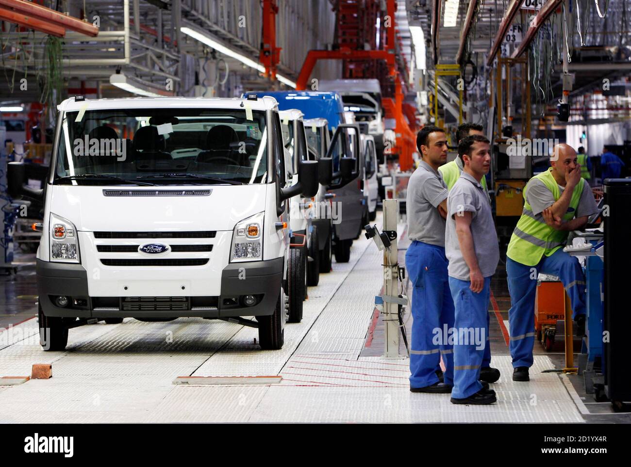 Workers Stand Next To Ford Transit Vans At The Ford Otosan Ihsaniye Car Plant Near The