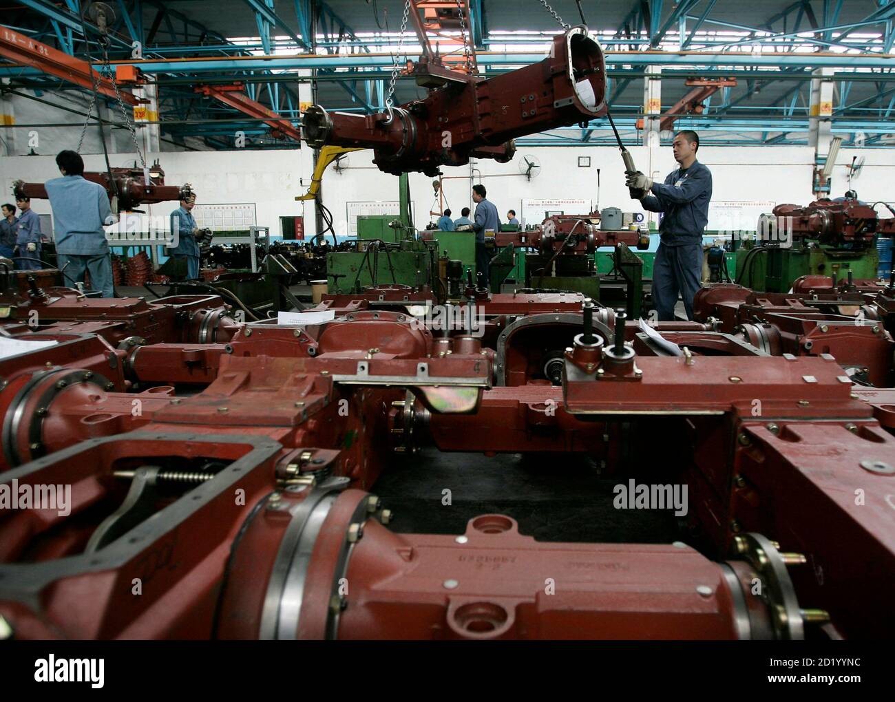 Chinese workers man the assembly line at China Yituo Group tractor factory  in Luoyang city in China's central eastern province of Henan May 12, 2006.  China Yituo Group is one of the