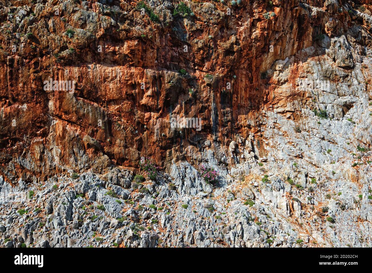 Textures of rocky sandstone cliffs at daytime, white and red rocks. Seitan Limania, Akrotiri peninsula, Chania region, Crete island, Greece Stock Photo