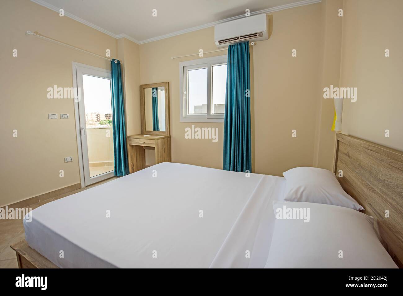 Interior design decor furnishing of luxury show home bedroom showing furniture and double bed with balcony Stock Photo