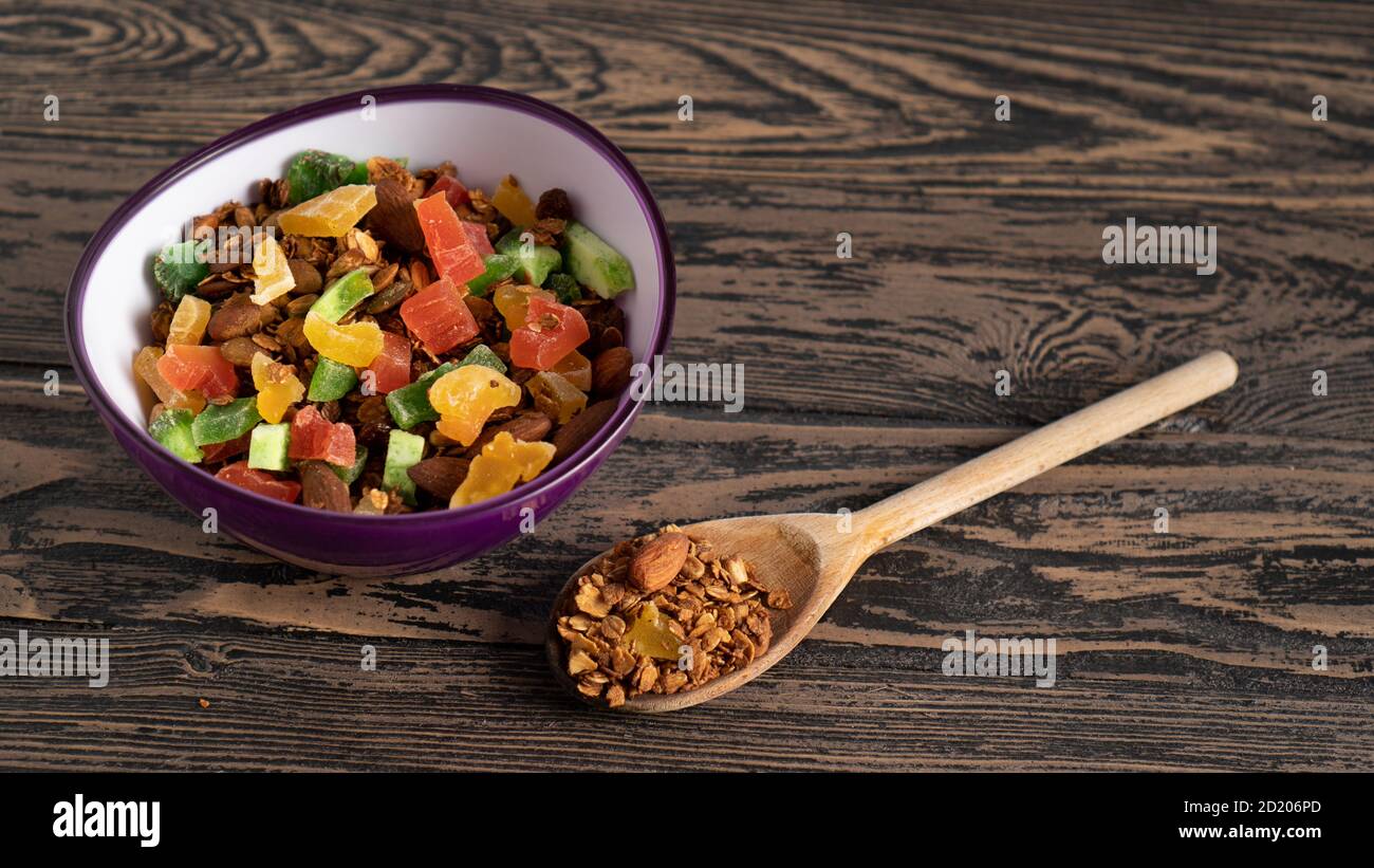 Baked flakes bowl on the table. Concept of a healthy, hearty and delicious breakfast. Backdrop for granola ads Stock Photo