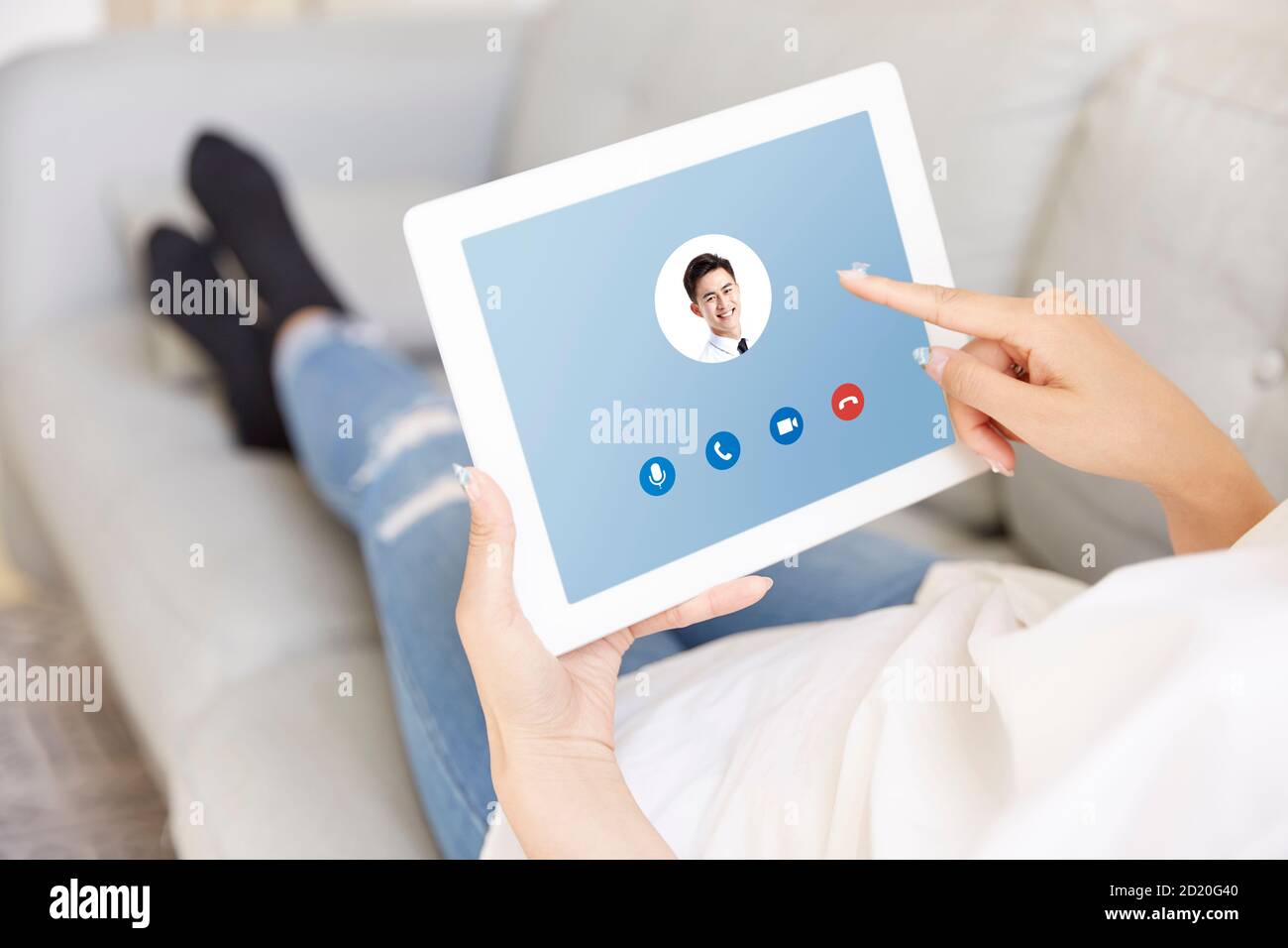 young asian woman working at home answering a video call from business colleague using digital tablet Stock Photo