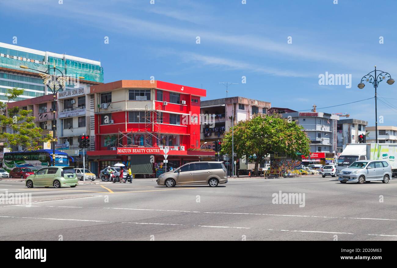 Kota Kinabalu, Malaysia - March 17, 2019: Jalan Tun Razak street view with cars and ordinary people walking the street Stock Photo