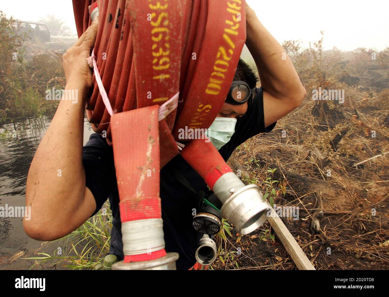 Malaysian Firefighter Carries Water Hose To Burnt Peat Land In Rokan Hilir In Indonesia S Riau Province A Malaysian Firefighter Carries A Water Hose To Burnt Peat Land In Rokan Hilir In Indonesia S<script async src=