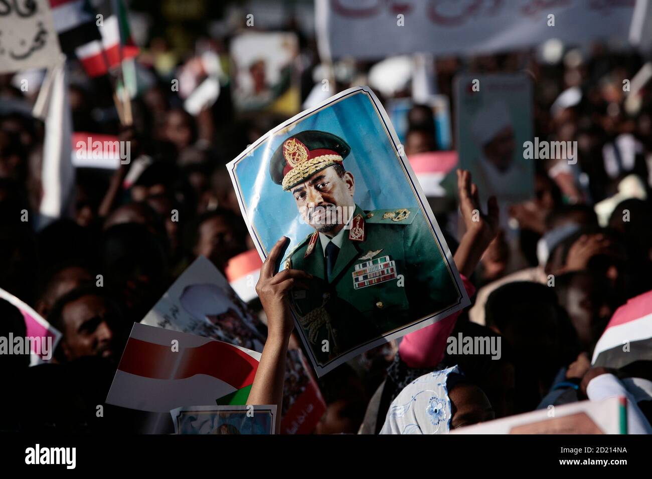 A supporter holds up a poster of Sudan's President Omar Hassan al-Bashir during a demonstration in Khartoum, against the International Criminal Court (ICC) for issuing an arrest warrant for Bashir March 4, 2009. The arrest warrant for Bashir for war crimes and crimes against humanity in Darfur is the first issued by the Hague-based court against a sitting head of state since it was set up in 2002. REUTERS/Zohra Bensemra (SUDAN) Stock Photo