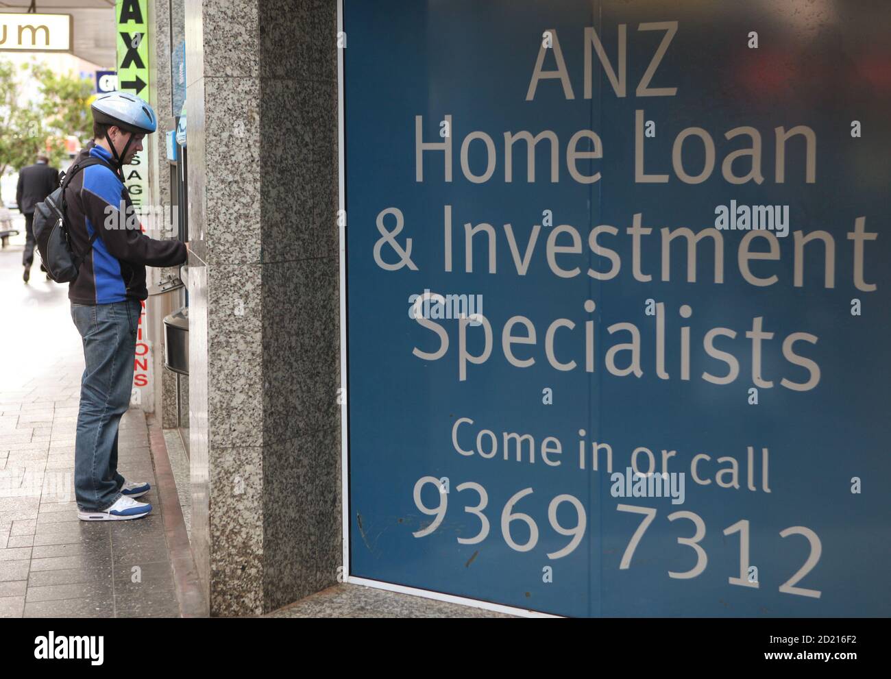 A Man Uses An Atm Next To A Banking Advertisement In Sydney October 7, 2009.  Australian Demand For Investment-Related Home Loans And Construction  Finance Jumped In August, Government Data Showed On Wednesday,