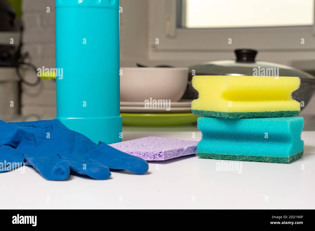https://c8.alamy.com/comp/2D2190P/set-of-dishwashing-detergents-on-the-kitchen-table-dirty-dishes-in-the-background-2D2190P.jpg