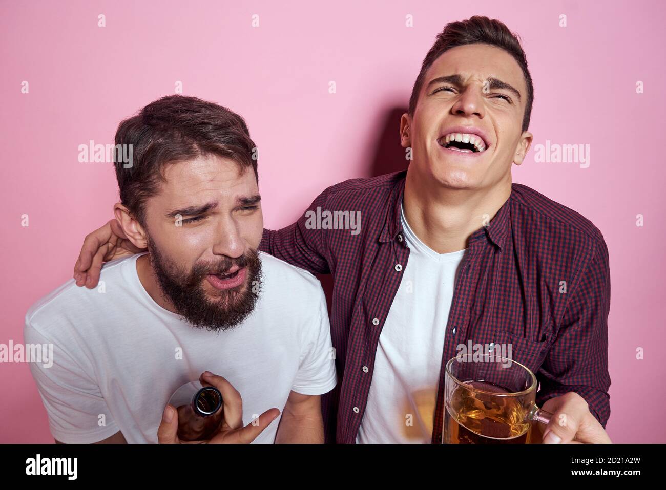 Two men drink beer friendship drunk alcohol lifestyle pink background Stock Photo Alamy